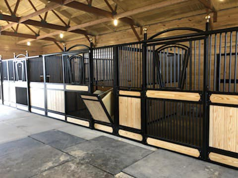 Stall Front No. 3B - Full grill door with hinged yoke opening, arch over door,  brass finials, JR Elite wood load, and hay chute