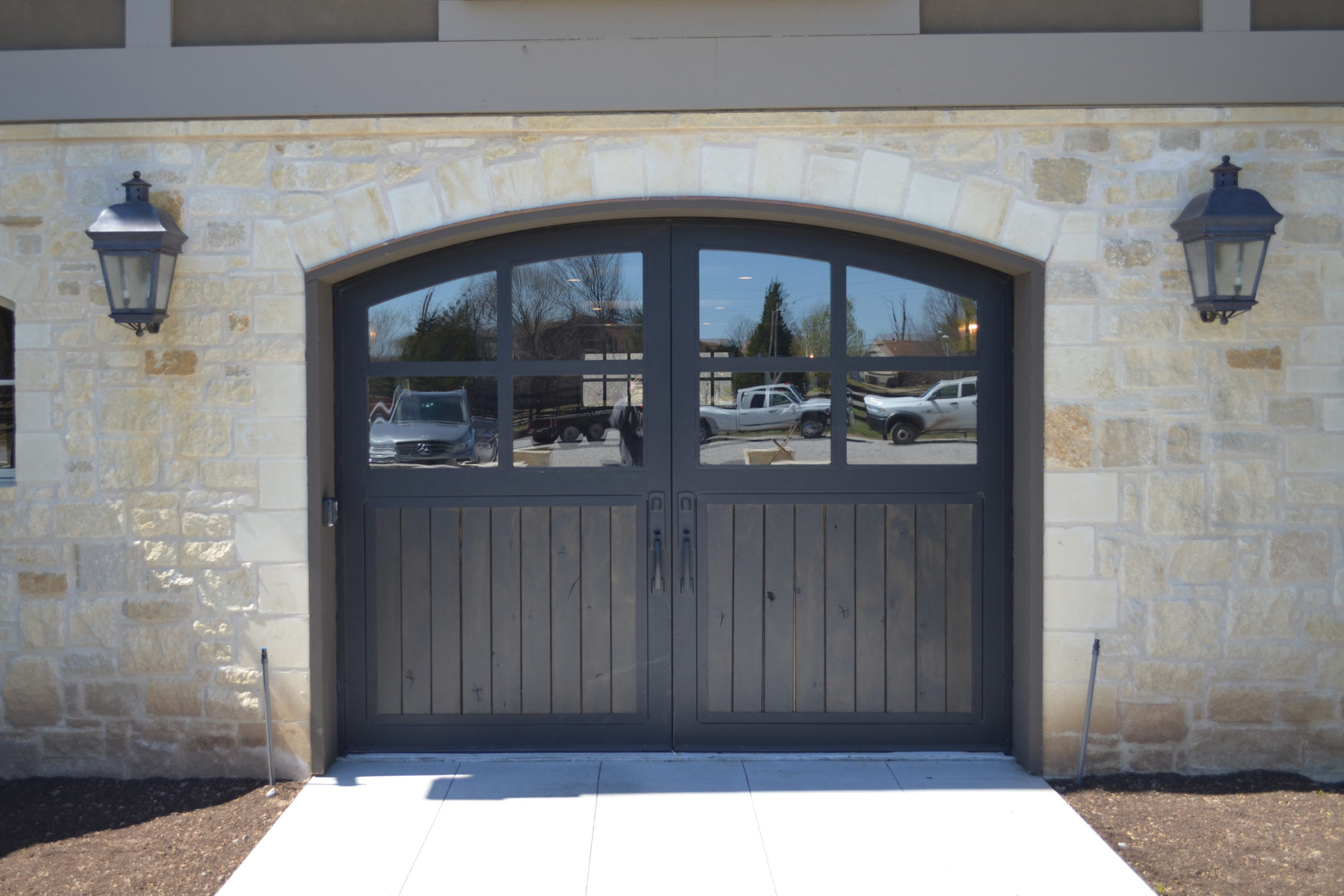Arched dark wooden vertical barn doors